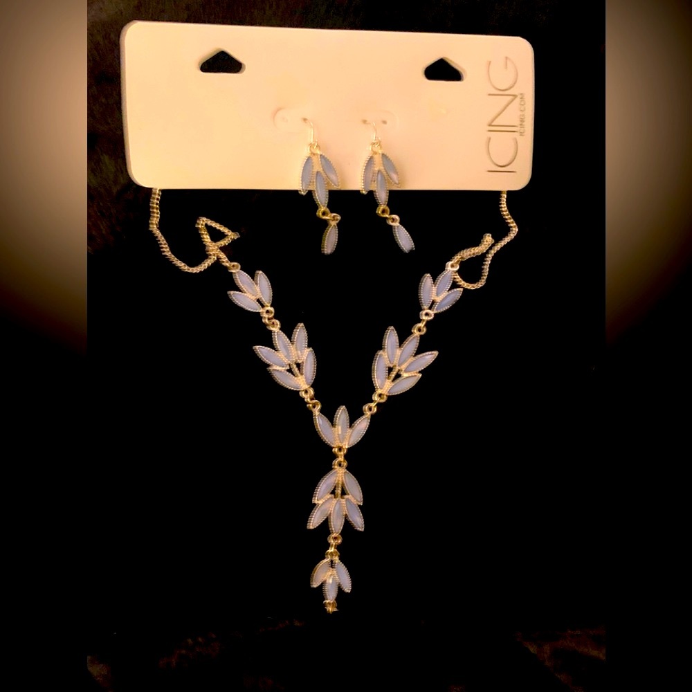 ICING gold tone necklace and earring set with light blue accents.